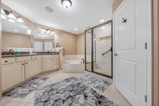 a large bathroom with a large mirror vanity and shower