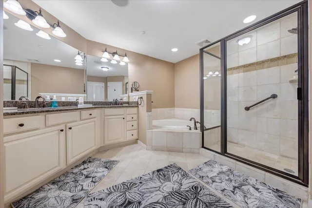 a large bathroom with a granite countertop sink a toilet a mirror and shower
