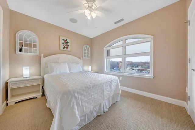 a bedroom with a large bed and a window