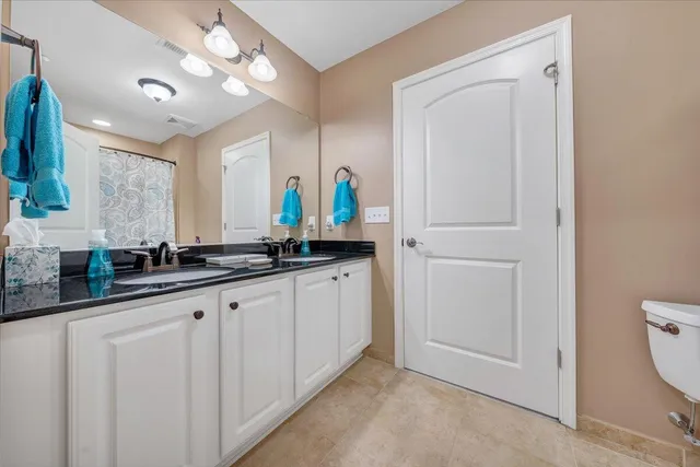 a bathroom with a double vanity sink and a mirror