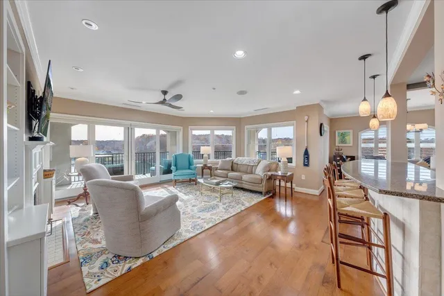 a living room with fireplace furniture and a large window