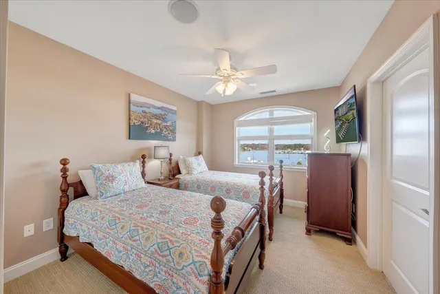 a bedroom with a large bed and a chandelier