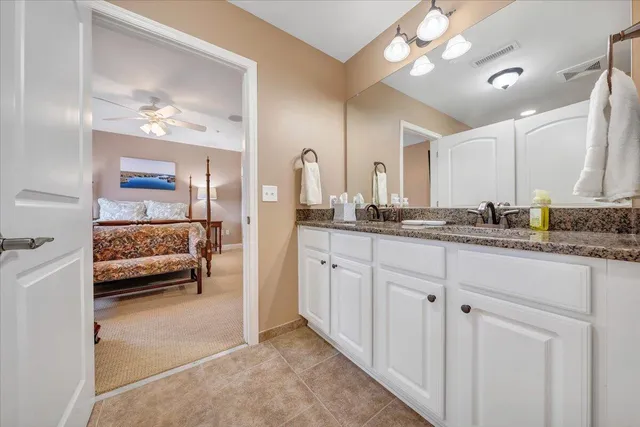 a en suite spacious bathroom with a double vanity sink and a mirror