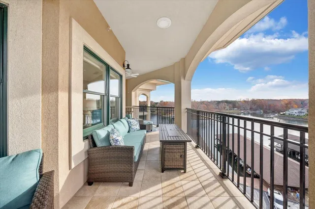 a balcony with furniture and a view of lake