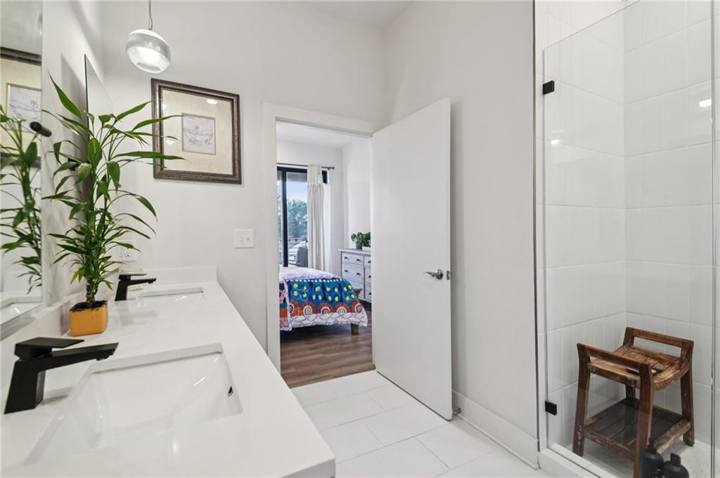 112 Rogers Street Northeast, Unit 409 Atlanta, GA 30317 - Photo 12 of 18 a hallway with a potted plant on the wall and a potted plant