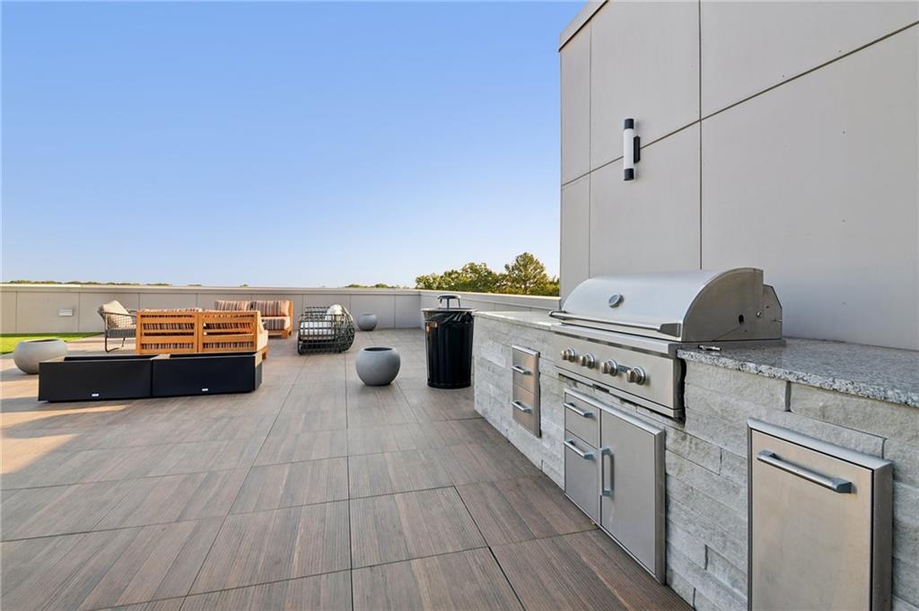 112 Rogers Street Northeast, Unit 409 Atlanta, GA 30317 - Photo 15 of 18 a kitchen with stainless steel appliances a sink and a stove