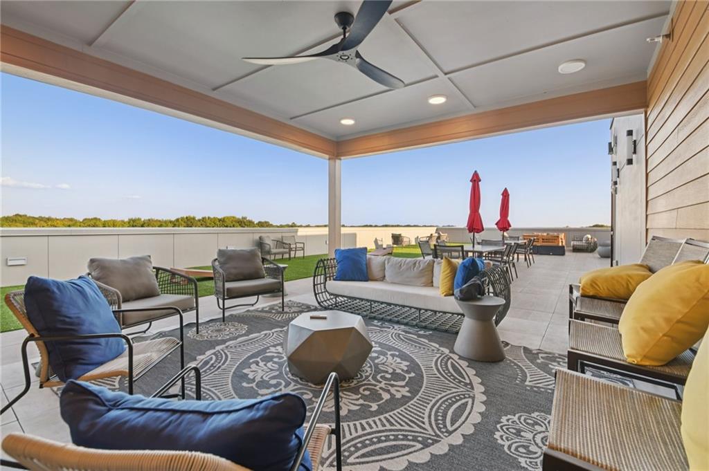 112 Rogers Street Northeast, Unit 409 Atlanta, GA 30317 - Photo 16 of 18 a living room with furniture and a floor to ceiling window