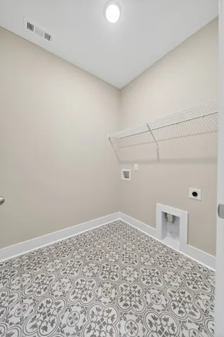 a large kitchen with a center island wooden floor stainless steel appliances and a window