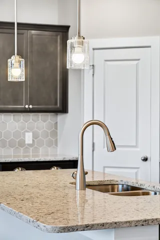 a kitchen with a sink dishwasher a stove and a refrigerator with wooden floor