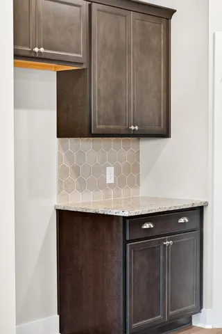 a view of a electric appliances a sink and a rug in a room