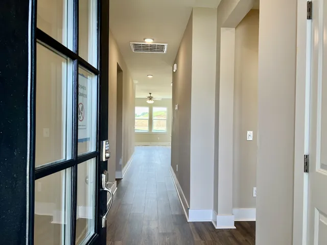 a view of hallway with wooden floor