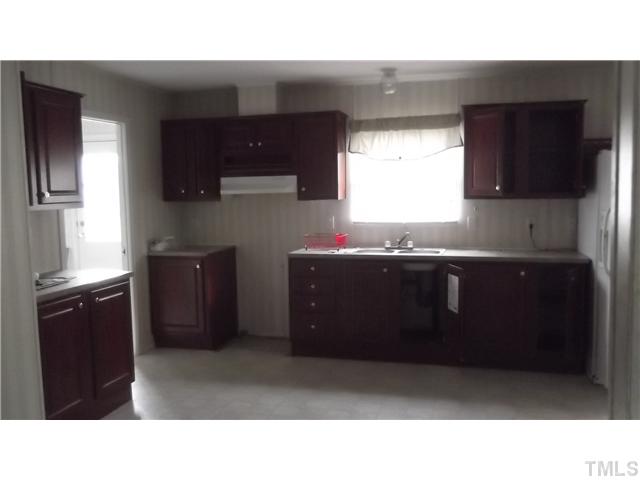731 Barnette Tingen Road Roxboro, NC 27574 - Photo 4 of 11 a kitchen with a sink and cabinets