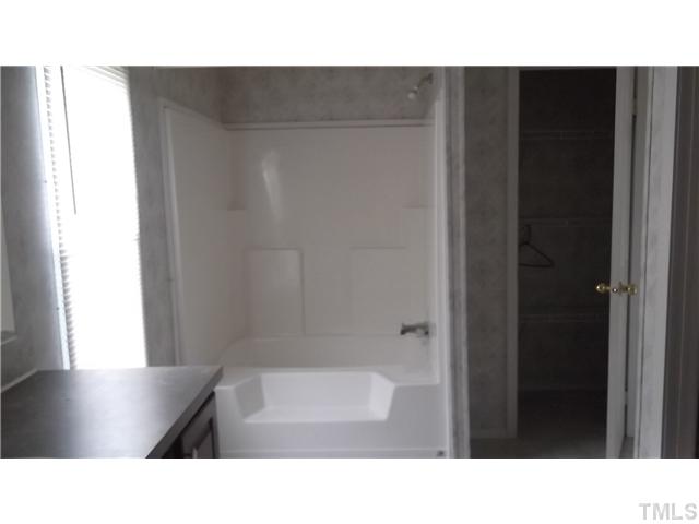731 Barnette Tingen Road Roxboro, NC 27574 - Photo 7 of 11 a bathroom with a sink and a bathtub