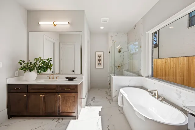 a spacious bathroom with a granite countertop sink and a mirror