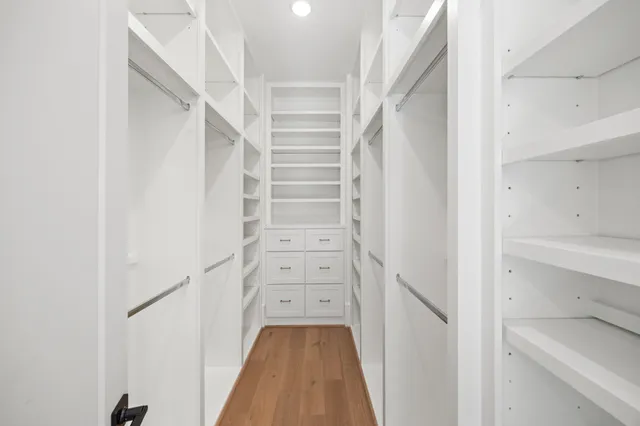 a view of walk in closet with empty racks
