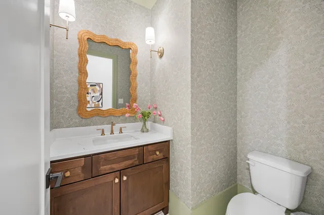 a bathroom with a toilet sink and mirror