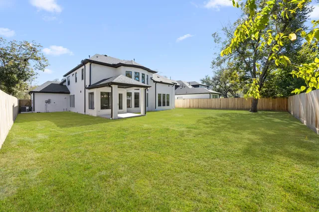 a front view of a house with yard and green space