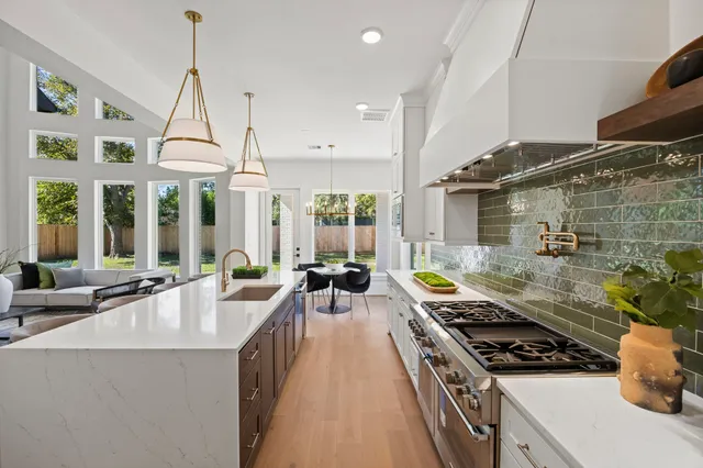 a kitchen with stove and cabinets