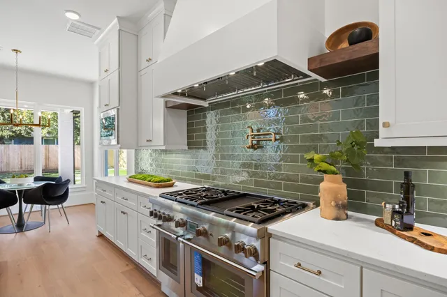 a kitchen with a stove and a wooden cabinets
