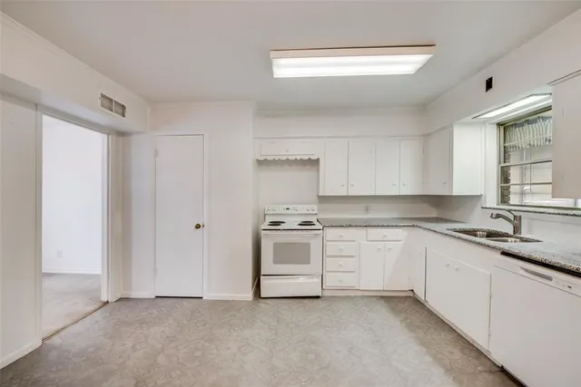 a kitchen with a sink stove and cabinets