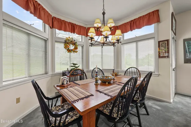 a view of a dining room with furniture wooden floor and chandelier