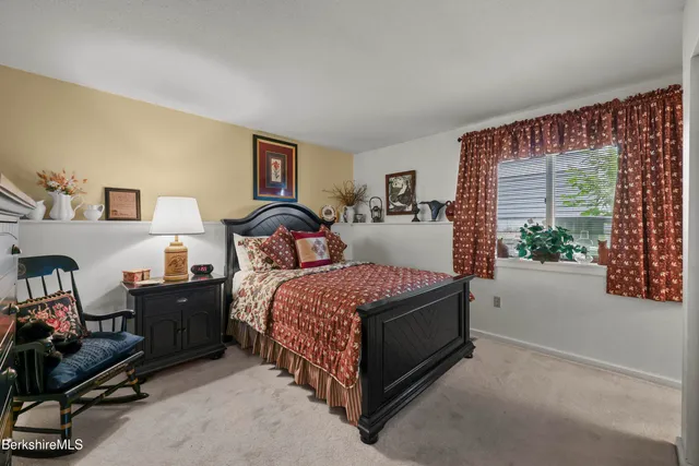 a bedroom with bed and a couch