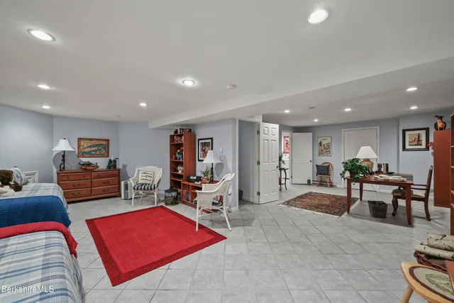 a living room with furniture a rug and a flat screen tv