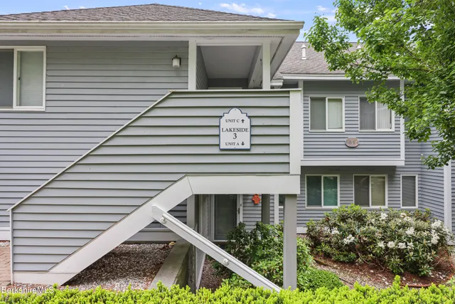 a front view of a house with plants