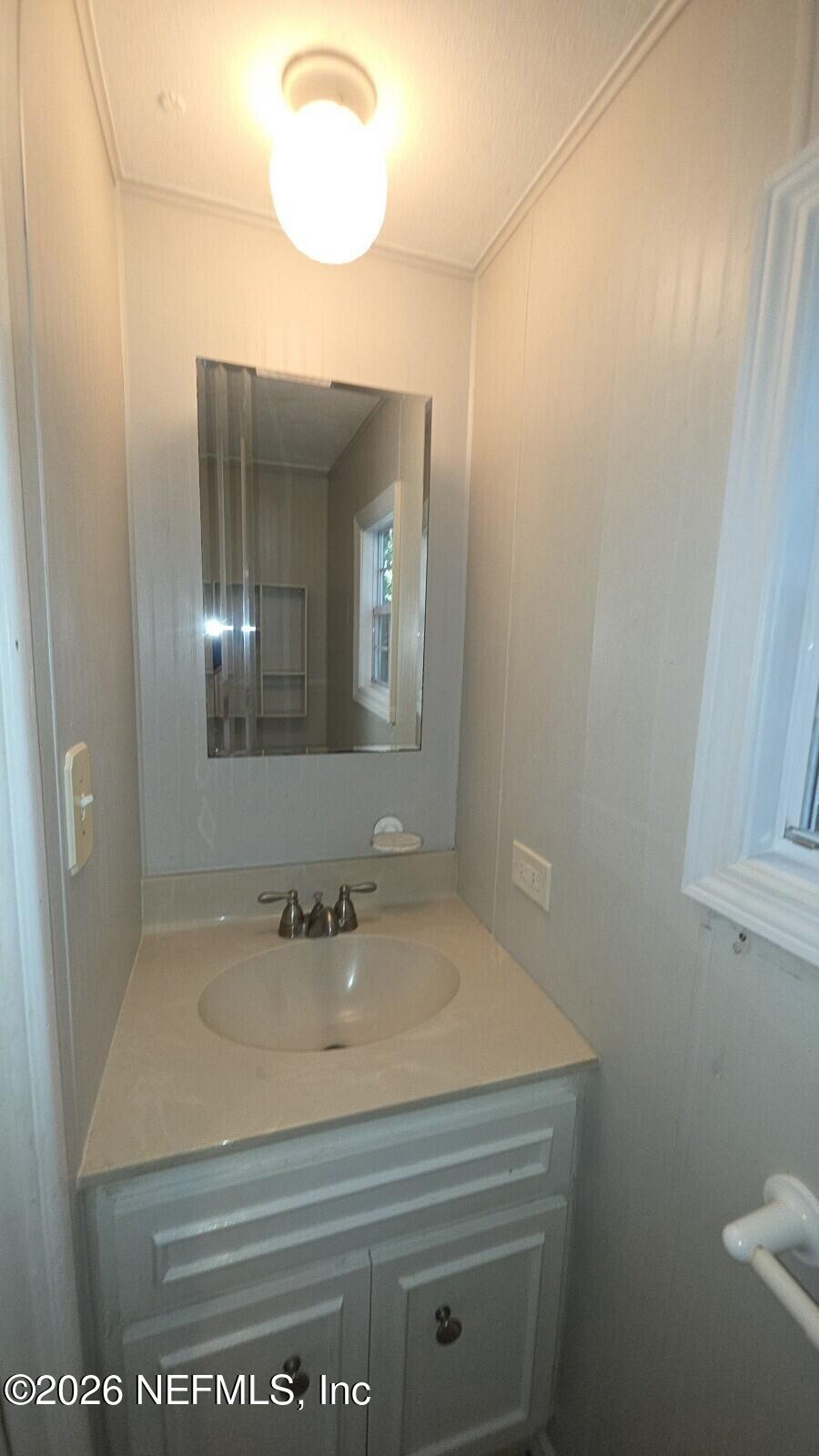 2781 Schaller Road St. Augustine, FL 32084 - Photo 8 of 9 a bathroom with a sink and a mirror