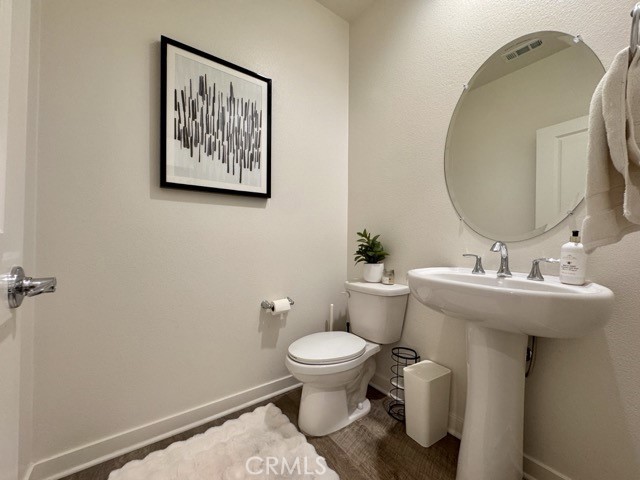 30411 Ridgecrest Road Winchester, CA 92596 - Photo 11 of 46 a bathroom with a toilet sink and mirror