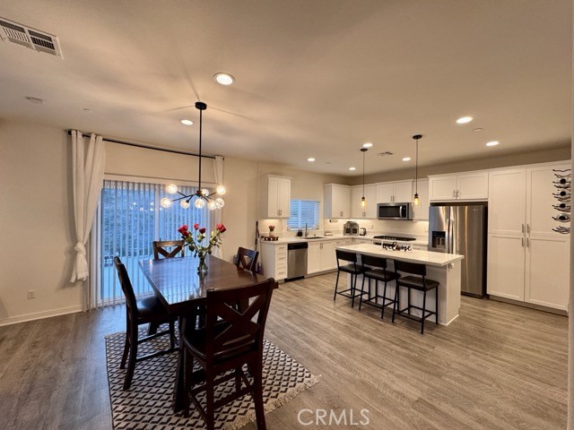 30411 Ridgecrest Road Winchester, CA 92596 - Photo 12 of 46 a view of a dining room with furniture wooden floor and chandelier
