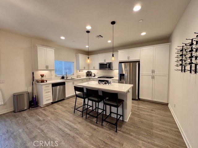 30411 Ridgecrest Road Winchester, CA 92596 - Photo 13 of 46 a kitchen with kitchen island granite countertop a sink a counter and stainless steel appliances