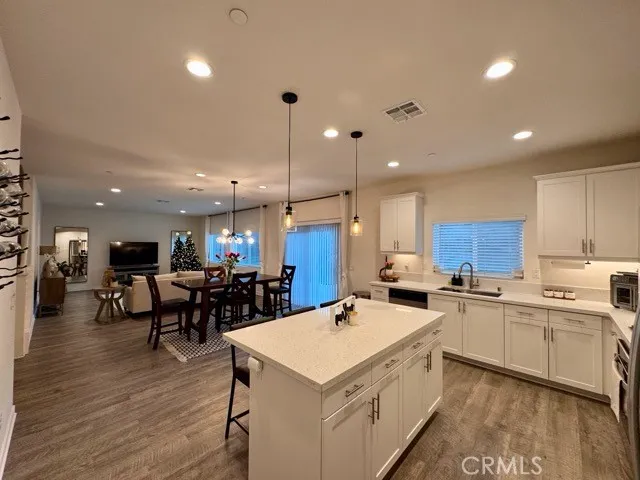 a large kitchen with a table and chairs