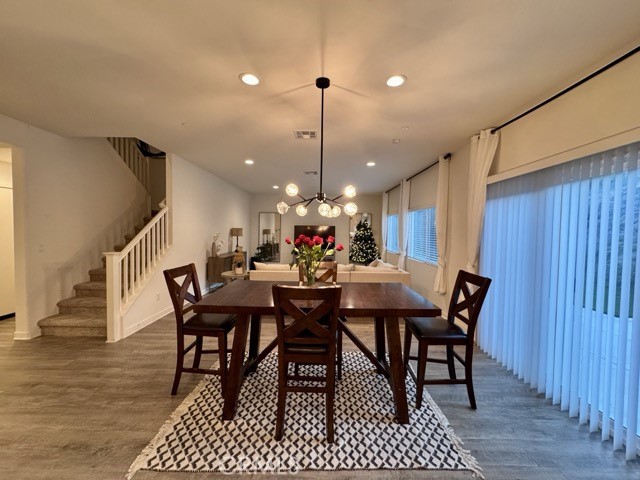 30411 Ridgecrest Road Winchester, CA 92596 - Photo 18 of 46 a dining room with furniture a chandelier and wooden floor