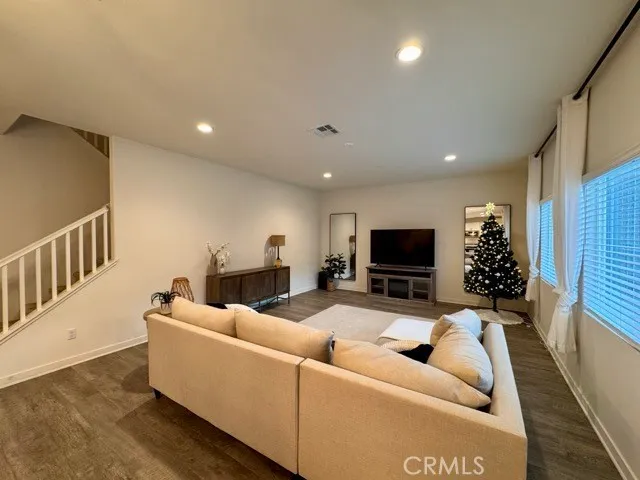 a living room with furniture flowers and a potted plant