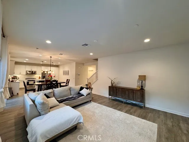 a view of a hallway view with wooden floor and staircase