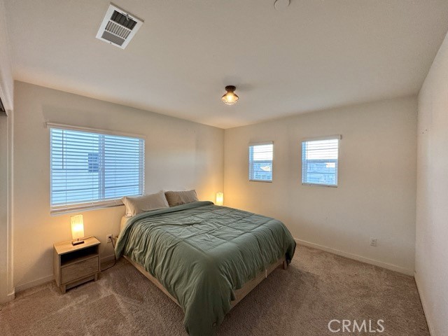 30411 Ridgecrest Road Winchester, CA 92596 - Photo 30 of 46 a bed sitting in a bedroom next to a window