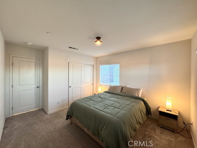 30411 Ridgecrest Road Winchester, CA 92596 - Photo 31 of 46 a bedroom with a bed and a lamp