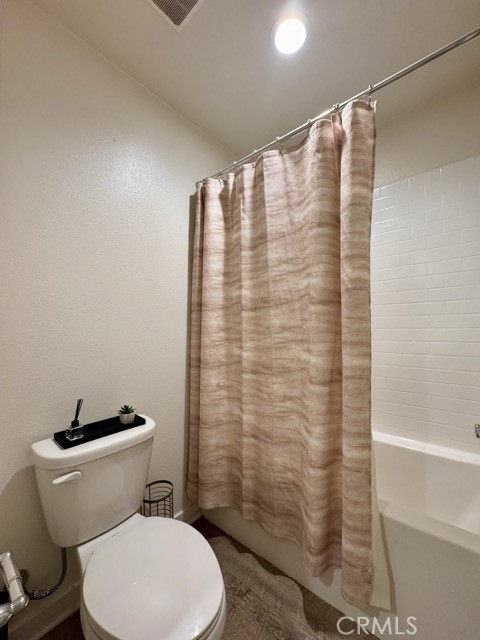 30411 Ridgecrest Road Winchester, CA 92596 - Photo 35 of 46 a white toilet sitting next to a shower curtain