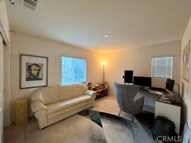 a spacious bedroom with a bed and a large mirror