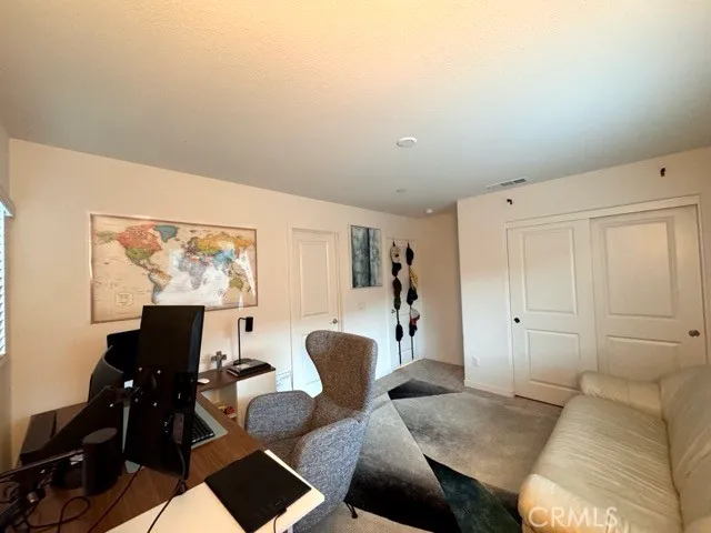 a bedroom with a bed and a television