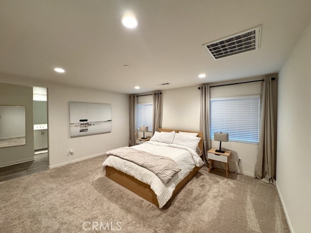 30411 Ridgecrest Road Winchester, CA 92596 - Photo 38 of 46 a spacious bedroom with a bed and a large mirror