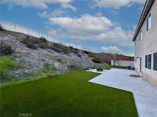 a backyard of a house with table and chairs
