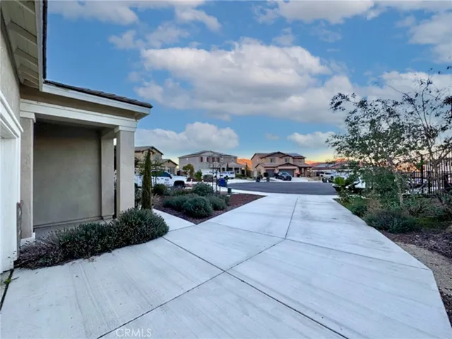 a front view of the house with plants