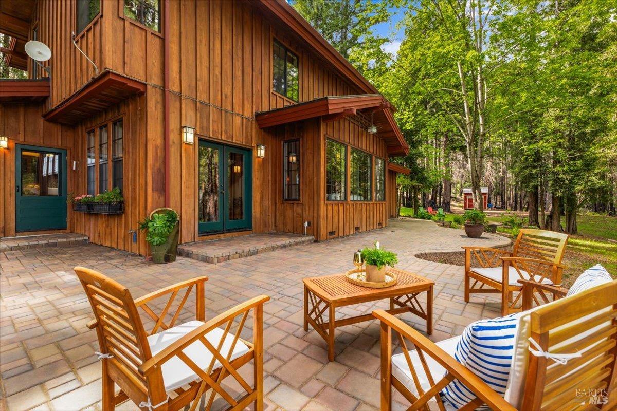 12076 Cloud Ridge Road Healdsburg, CA 95448 - Photo 32 of 72 Paver patio wraps around the main house with multiple doors to access the home.