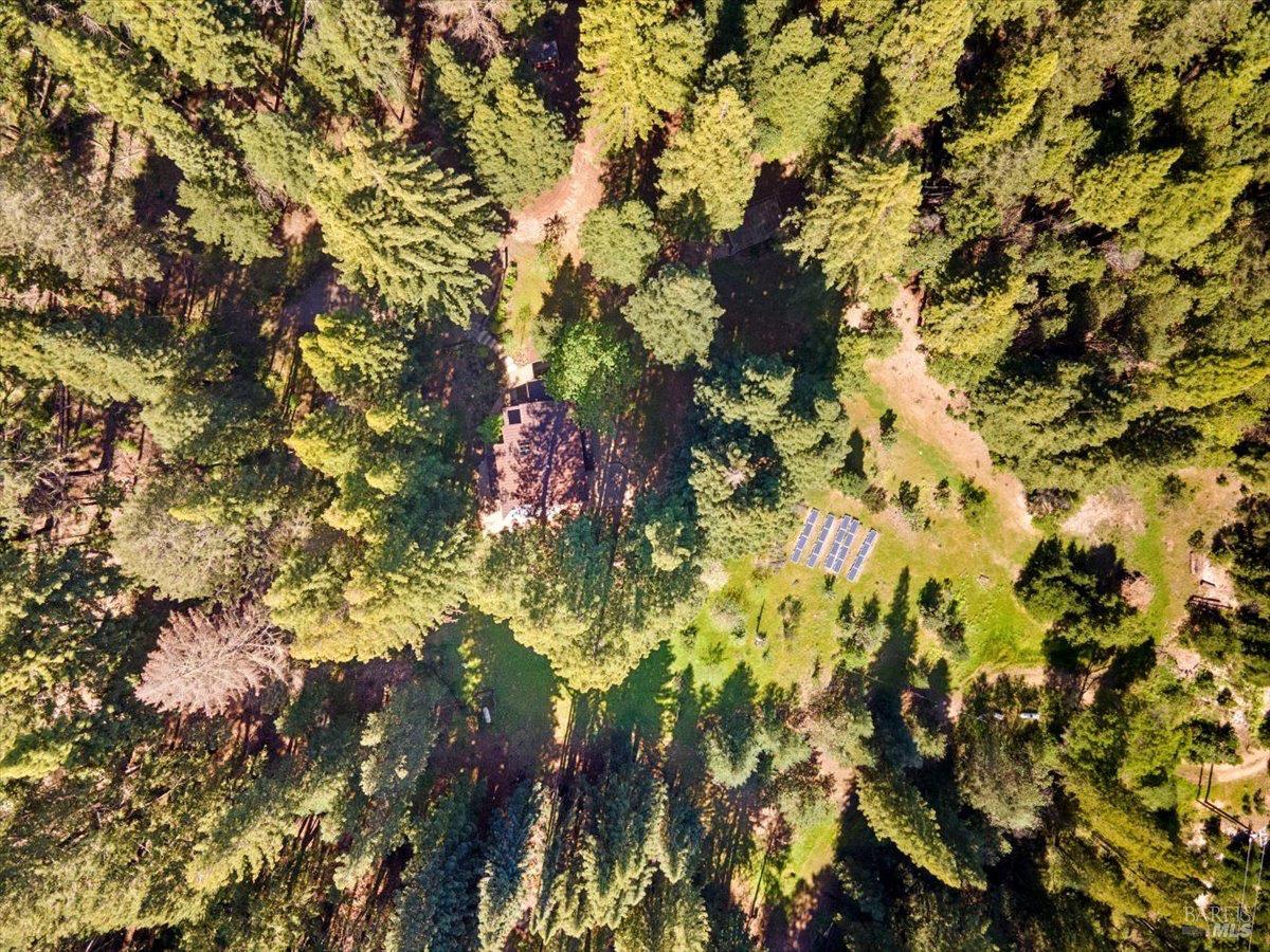 12076 Cloud Ridge Road Healdsburg, CA 95448 - Photo 70 of 72 Closer aerial view of main house showing driveway, open spaces, and solar field.