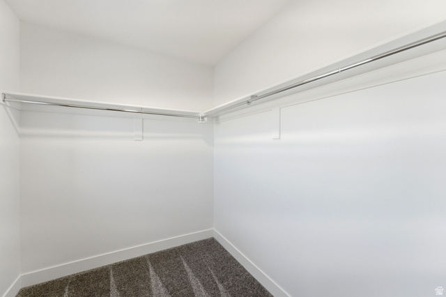 645 West 880th Street South Fillmore, UT 84631 - Photo 10 of 22 Walk-in closet featuring plush grey carpet, white baseboards, and two levels of chrome hanging rods