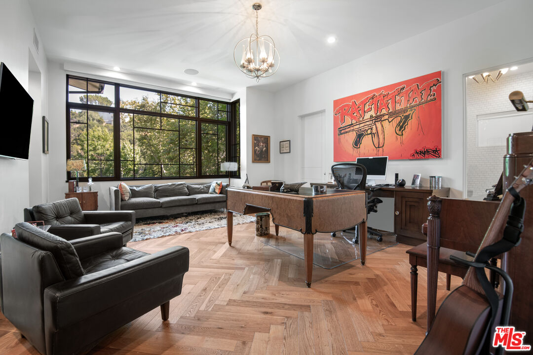 16001 Woodvale Road Encino, CA 91436 - Photo 14 of 49 a living room with furniture and a flat screen tv