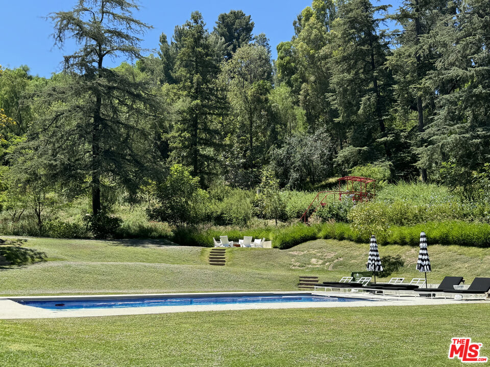 16001 Woodvale Road Encino, CA 91436 - Photo 2 of 26 a view of a house with a big yard