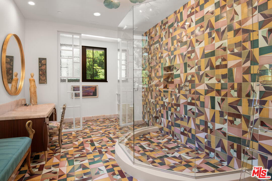 16001 Woodvale Road Encino, CA 91436 - Photo 21 of 49 a view of a bathroom with a sink and a mirror